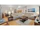 Spacious living room with wood floors, an open concept, and comfortable seating arrangement at 8294 Se 177Th Winterthur Loop, The Villages, FL 32162