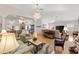 Expansive living area with a chandelier, open floor plan, wood floors, and modern furnishings at 8294 Se 177Th Winterthur Loop, The Villages, FL 32162