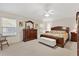 Comfortable main bedroom featuring a decorative bed, dresser, and ample natural light at 8294 Se 177Th Winterthur Loop, The Villages, FL 32162
