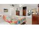 Bright main bedroom with a decorative bed, dresser, mounted TV, and sliding door to screened patio at 8294 Se 177Th Winterthur Loop, The Villages, FL 32162