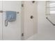 Modern shower with glass doors, a mounted shower head and towel rack with starfish towel detail at 8294 Se 177Th Winterthur Loop, The Villages, FL 32162