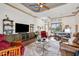 Inviting living room with ceiling fan, entertainment center, and adjacent dining area at 8888 Beacon Hill Ave, Mount Dora, FL 32757