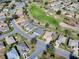 Lovely aerial view of homes surrounding a lush green golf course with mature landscaping at 9052 Se 130Th Loop, Summerfield, FL 34491