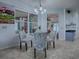 Cozy dining area features a glass table, patterned chairs, and bright natural light at 9052 Se 130Th Loop, Summerfield, FL 34491