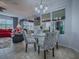 Open dining area with a glass table, patterned chairs, and seamless access to the living room at 9052 Se 130Th Loop, Summerfield, FL 34491