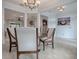Spacious dining area with decorative lighting, neutral colors, and views into adjacent rooms at 9052 Se 130Th Loop, Summerfield, FL 34491
