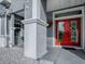 Close-up of the front entryway featuring a vibrant red double door with decorative glass panels at 9052 Se 130Th Loop, Summerfield, FL 34491