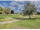 Beautiful golf course landscape with mature trees, manicured greens, and a winding path at 9052 Se 130Th Loop, Summerfield, FL 34491