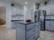 Lovely kitchen showcasing gray cabinets, stainless steel appliances, and a functional center island at 9052 Se 130Th Loop, Summerfield, FL 34491