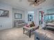 Cozy living room with tile flooring, neutral-toned furniture, and a decorative ceiling fan at 9052 Se 130Th Loop, Summerfield, FL 34491