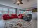 Bright living room with a decorative rug, a large sectional sofa, and ample natural light at 9052 Se 130Th Loop, Summerfield, FL 34491
