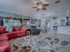 Expansive living room with a colorful rug, large windows, and easy access to the kitchen and lanai at 9052 Se 130Th Loop, Summerfield, FL 34491