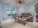 Open-concept living area featuring comfortable seating, a ceiling fan, and access to the lanai at 9052 Se 130Th Loop, Summerfield, FL 34491