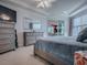 Spacious main bedroom features dual dressers, a king-size bed, and bright natural light at 9052 Se 130Th Loop, Summerfield, FL 34491