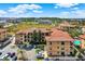 Aerial view of a residential community with multiple buildings, parking, and lush landscaping and ponds at 907 Charo Pkwy # 915, Davenport, FL 33897