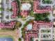 Overhead view of the condo community featuring multiple buildings, swimming pool, parking, and lush landscaping at 907 Charo Pkwy # 915, Davenport, FL 33897