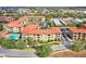 Aerial view of a condo community with multiple buildings, a pool area, parking, and lush landscaping at 907 Charo Pkwy # 915, Davenport, FL 33897