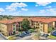 An aerial shot of a condo community featuring multiple units with red tiled roofs and lush green landscaping at 907 Charo Pkwy # 915, Davenport, FL 33897
