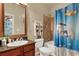 The inviting full bathroom features tile floors, a large mirror, and a shower over the tub at 907 Charo Pkwy # 915, Davenport, FL 33897