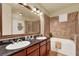 Well-lit bathroom with a double sink vanity, soaking tub, and tiled walls at 907 Charo Pkwy # 915, Davenport, FL 33897