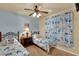 The bright bedroom has twin beds, a ceiling fan, and a charming design that will spark imagination at 907 Charo Pkwy # 915, Davenport, FL 33897