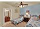 This bedroom includes a ceiling fan, twin beds, and a lovely connected bathroom at 907 Charo Pkwy # 915, Davenport, FL 33897