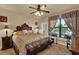 Main bedroom featuring a large bed with decorative pillows, a window, and neutral decor at 907 Charo Pkwy # 915, Davenport, FL 33897