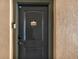 This front door features a black door with apartment number and smart lock at 907 Charo Pkwy # 915, Davenport, FL 33897