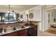 Open kitchen area featuring a stainless steel sink, tiled backsplash, and an adjoining living area at 907 Charo Pkwy # 915, Davenport, FL 33897