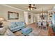 Inviting living room featuring a comfortable blue sofa, an ottoman, and a view of the dining area at 907 Charo Pkwy # 915, Davenport, FL 33897