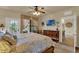 Bright bedroom featuring a TV, dresser, and an exit to the patio with lots of natural light at 907 Charo Pkwy # 915, Davenport, FL 33897