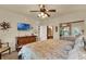 Sunlit bedroom showcasing a TV, dresser, and mirrored closet doors at 907 Charo Pkwy # 915, Davenport, FL 33897