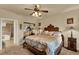 Comfortable bedroom with a ceiling fan, carpet flooring, and a closet with mirrored doors at 907 Charo Pkwy # 915, Davenport, FL 33897