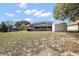 Expansive backyard with a screened-in pool and storage shed at 909 Palm Forest Ln, Minneola, FL 34715