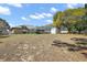 Spacious backyard featuring a screened-in pool and lush greenery at 909 Palm Forest Ln, Minneola, FL 34715