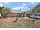 Charming single-story home featuring a well-maintained front yard, a driveway, and an attached garage at 909 Palm Forest Ln, Minneola, FL 34715