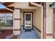 Welcoming front entrance with brown door, storm door, and security camera at 909 Palm Forest Ln, Minneola, FL 34715