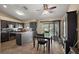 Modern kitchen with island table, dark cabinets and access to backyard and pool at 909 Palm Forest Ln, Minneola, FL 34715