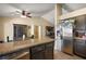 Modern kitchen featuring stainless steel appliances and an island with granite countertops at 909 Palm Forest Ln, Minneola, FL 34715