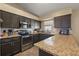 Well-equipped kitchen with granite countertops and stainless steel appliances at 909 Palm Forest Ln, Minneola, FL 34715