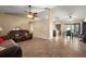 An open-concept living space with tile flooring, comfortable seating, and seamless flow to the kitchen area at 909 Palm Forest Ln, Minneola, FL 34715