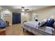 A spacious main bedroom with tiled floors, a fan, and a connecting bathroom at 909 Palm Forest Ln, Minneola, FL 34715