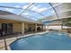 Inviting screened-in pool area with a spacious patio for outdoor enjoyment at 909 Palm Forest Ln, Minneola, FL 34715