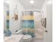 Clean bathroom with a tub and colorful shower curtain at 9312 Se 172Nd Wayside Pl, The Villages, FL 32162