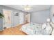 This spacious bedroom has a ceiling fan, wood floor, and doorways leading to the bath and hallway at 9312 Se 172Nd Wayside Pl, The Villages, FL 32162