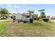 Corner lot home featuring mature landscaping, a manicured lawn and decorative rock garden at 9312 Se 172Nd Wayside Pl, The Villages, FL 32162