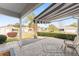 Comfortable front porch featuring brick pavers, retractable awning, and one chair at 9312 Se 172Nd Wayside Pl, The Villages, FL 32162