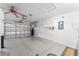 A spacious garage with epoxy floor, shelving, and a ceiling fan at 9312 Se 172Nd Wayside Pl, The Villages, FL 32162