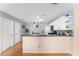 Charming kitchen featuring a breakfast bar, white cabinetry, black appliances, and stylish backsplash at 9312 Se 172Nd Wayside Pl, The Villages, FL 32162