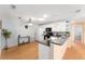 Bright kitchen with white appliances, cabinetry, modern lighting, and grey countertop at 9312 Se 172Nd Wayside Pl, The Villages, FL 32162